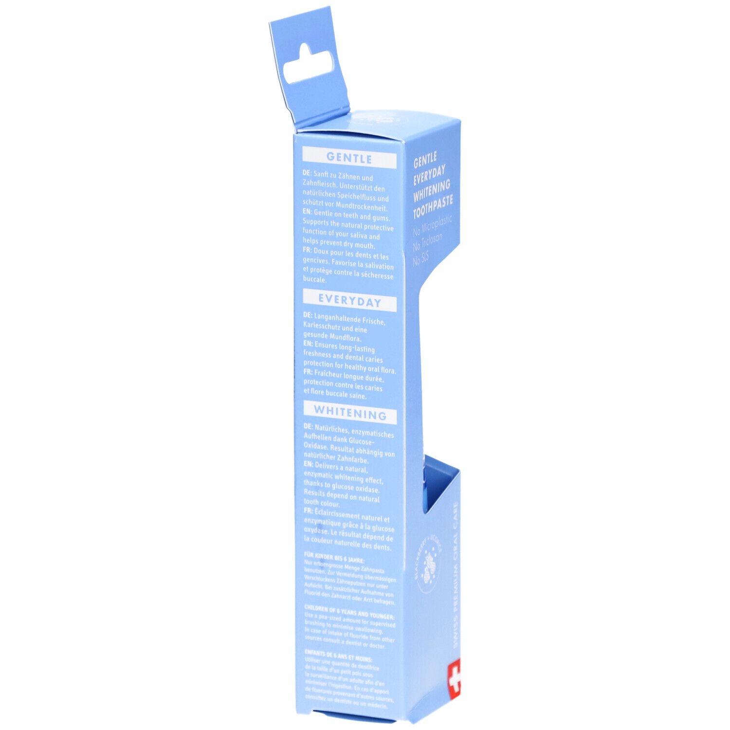 Emballage bleu clair avec texte. Blanchiment quotidien doux. Informations produit multilingues. Croix suisse.