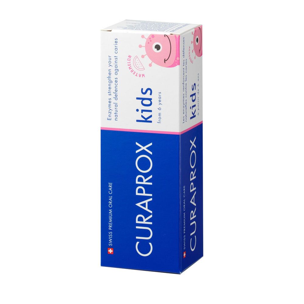Emballage carton, blanc et bleu. CURAPROX kids, personnage de dessin animé. Texte : Enzymes renforcent vos défenses naturelles contre les caries. Pour enfants de 6 ans.