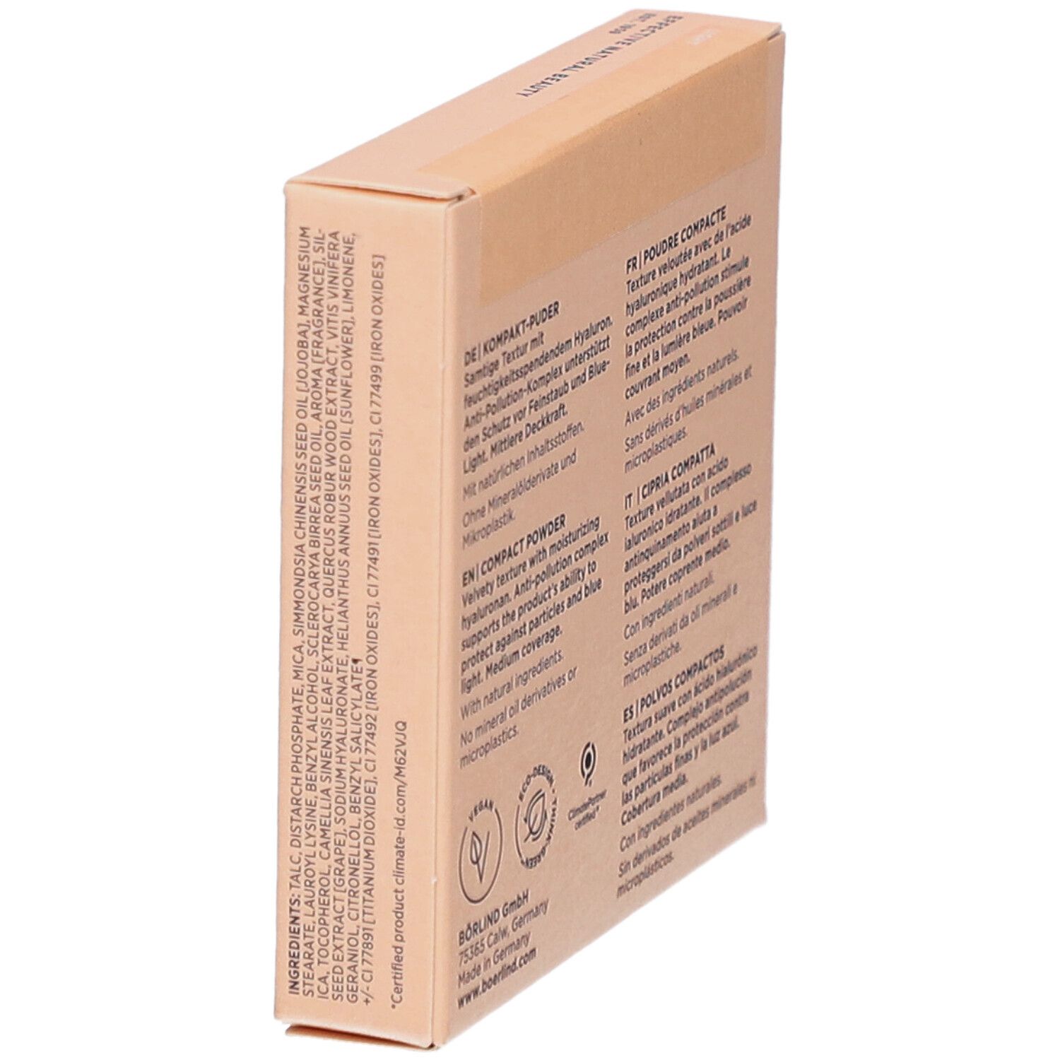Boîte de poudre compacte en biais. Ingrédients et texte multilingue au dos. Logo vegan.