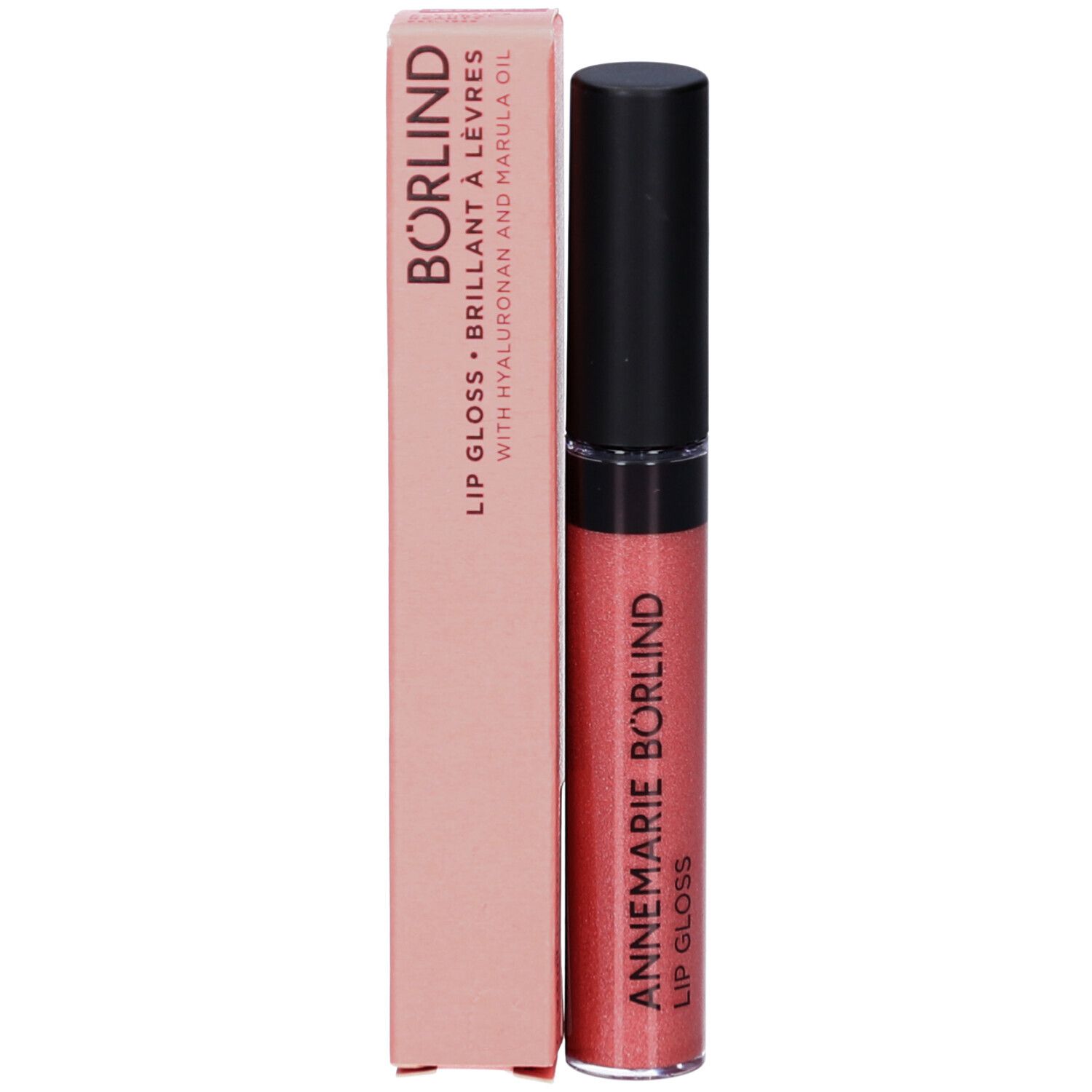 Tube de gloss et emballage. Inscription: ANNEMARIE BÖRLIND, Lipgloss. Texture rose scintillante.