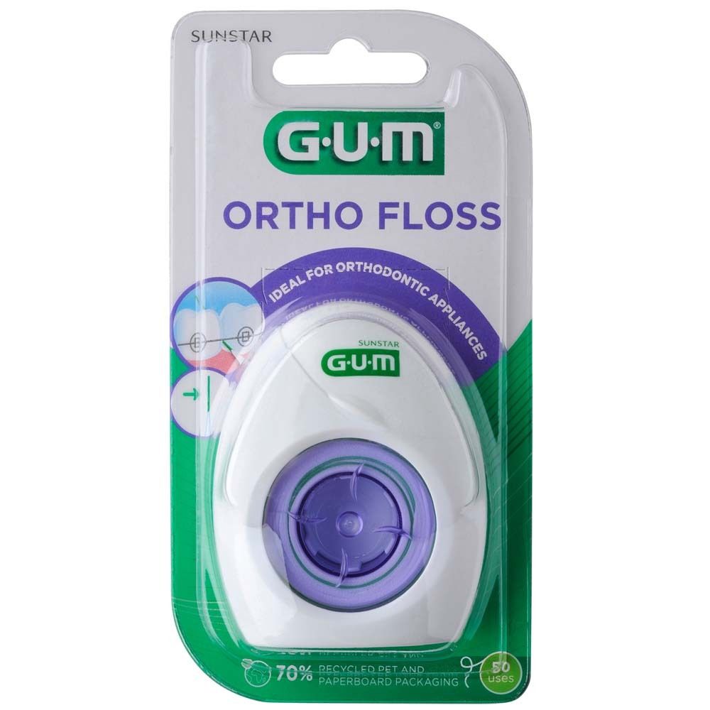 Distributeur de fil dentaire en blister. Boîtier blanc avec accents violets. Texte : GUM ORTHO FLOSS. Idéal pour appareils orthodontiques.