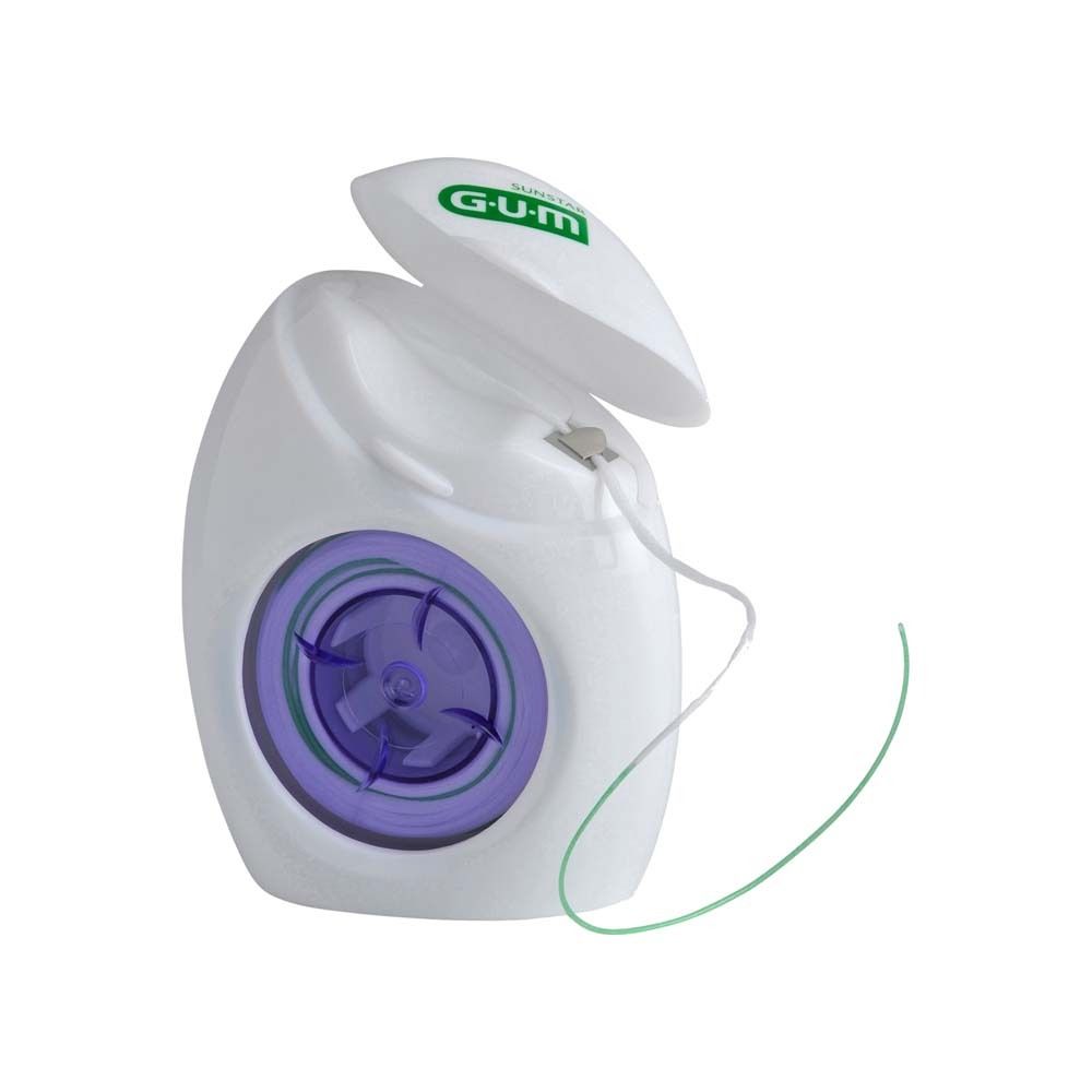 Distributeur de fil dentaire blanc avec couvercle ouvert. Bobine violette visible. Fil vert extrait.