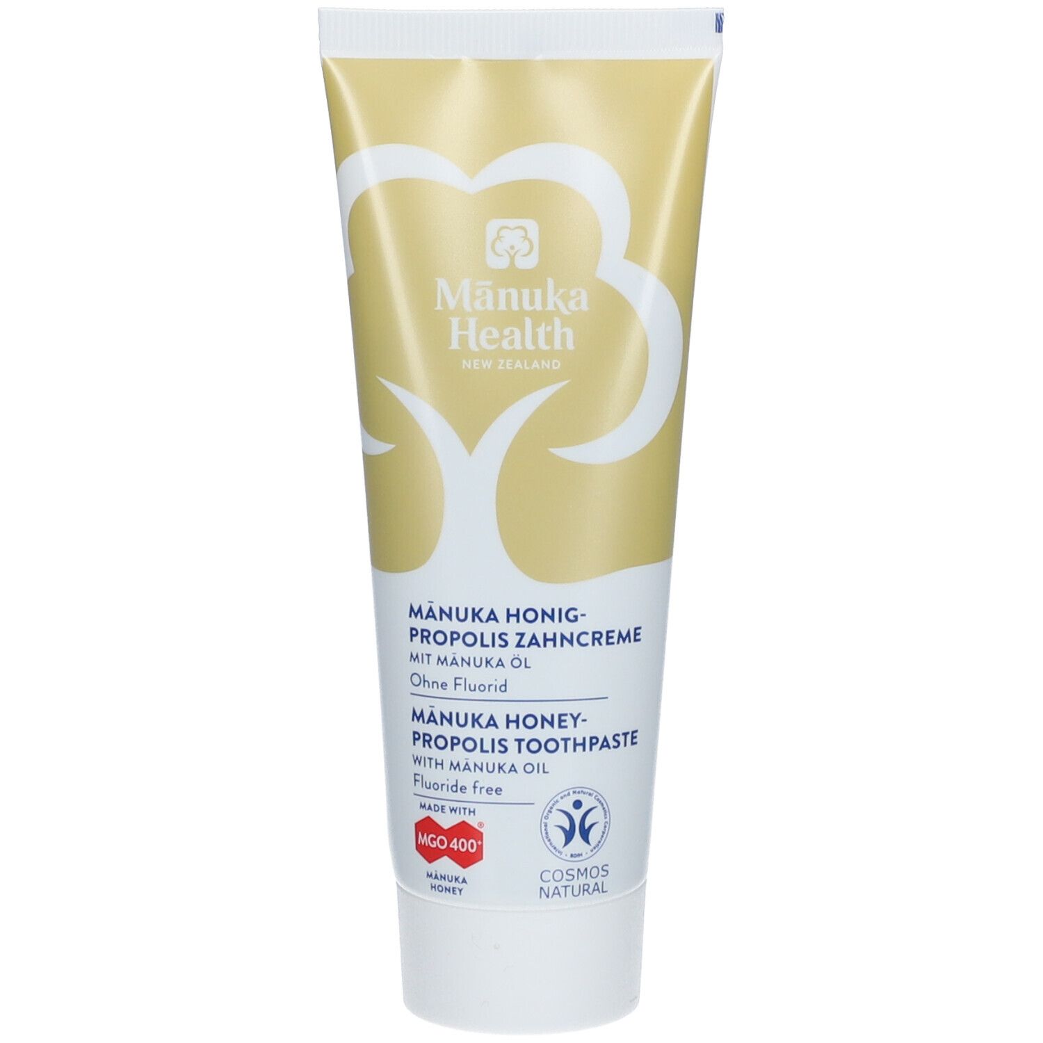 Tube de dentifrice jaune et blanc. Inscription: Manuka Health, Manuka Honig-Propolis Zahncreme, sans fluor. Logos et certifications.