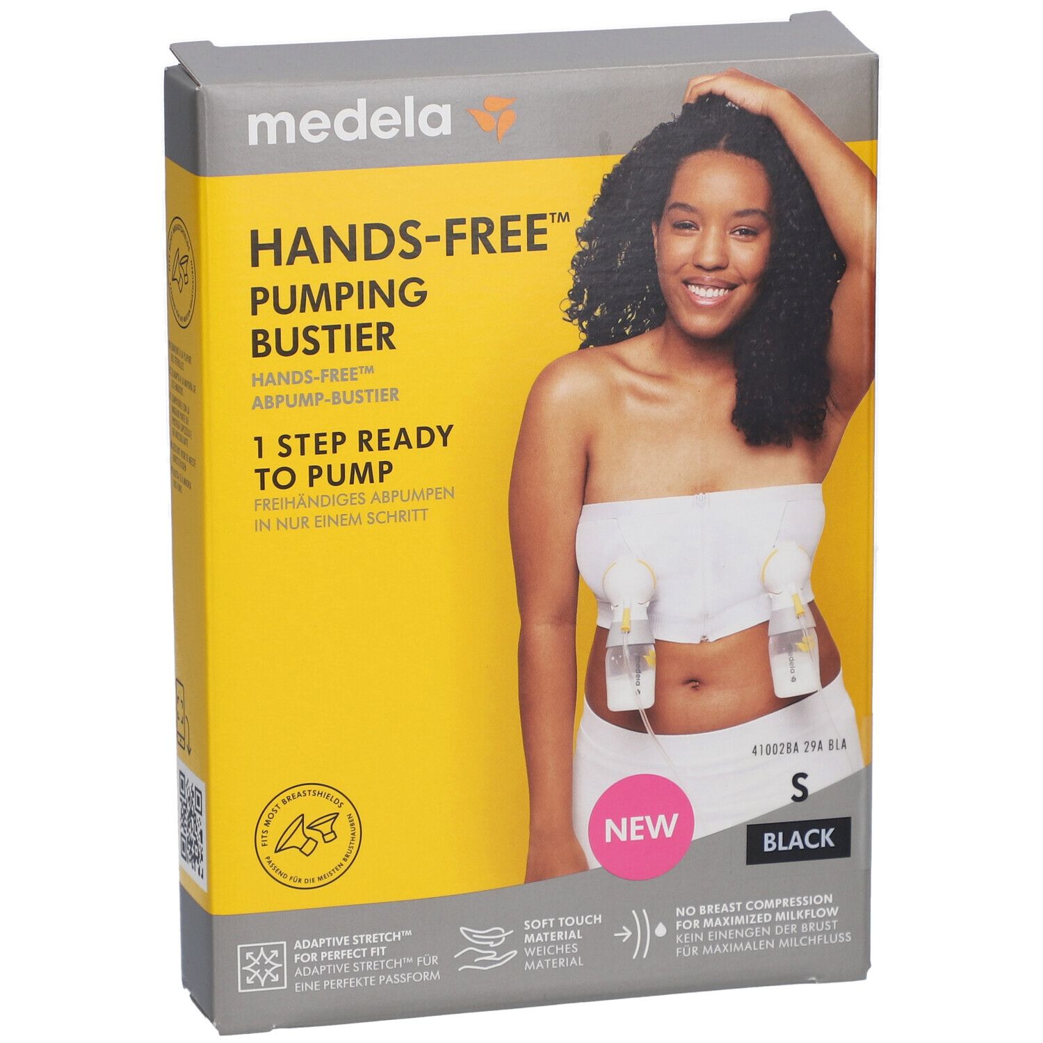 Emballage avec image du produit. Bustier mains libres, taille S, noir. Marque Medela. Fond jaune.