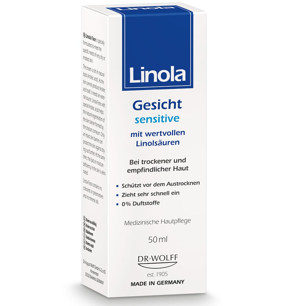 Emballage de la crème Linola Gesicht sensitive. Boîte blanche avec couvercle et texte bleus. Soin médical de la peau.
