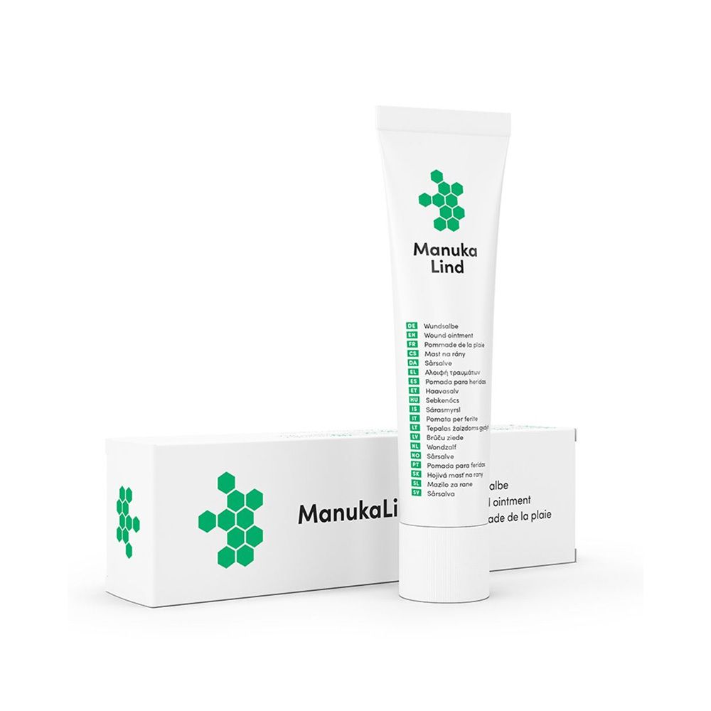 Tube et boîte sur fond blanc. Manuka Lind est écrit sur le tube. Il y a un motif hexagonal vert sur la boîte.