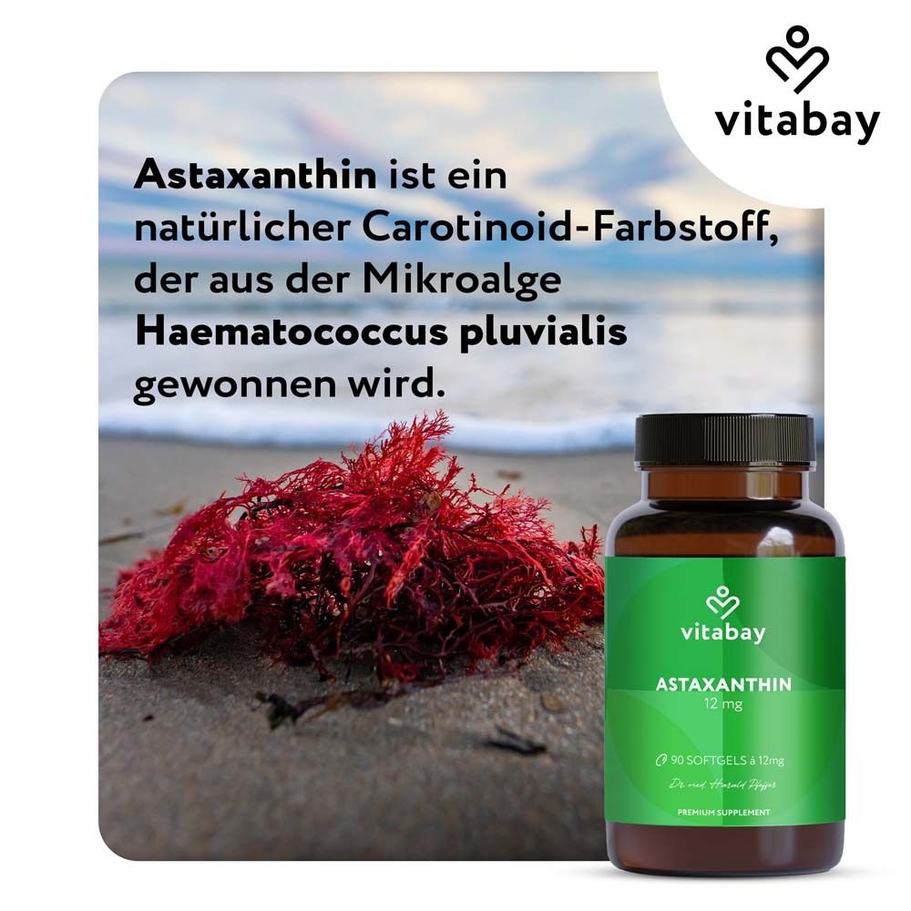 Bouteille brune avec "vitabay Astaxanthine 12 mg". Fagot d'algues rouges sur la plage.