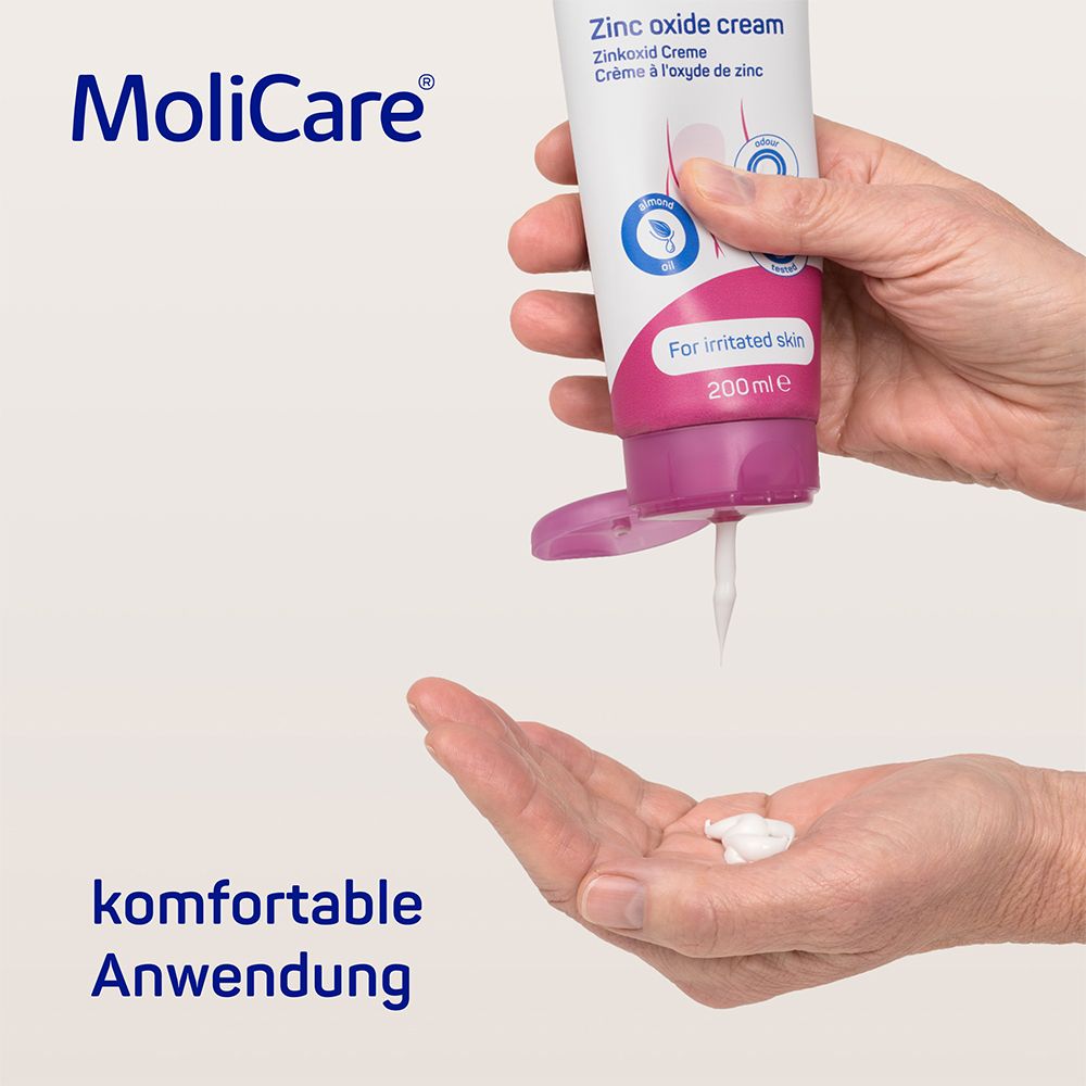 Tube de crème MoliCare Skin à l'oxyde de zinc. La crème est pressée du tube. Texte : Application confortable.