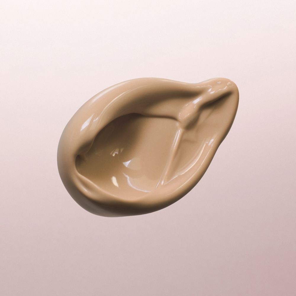 Louis Widmer nutriderm crème de jour teintée UV 20, Bronze 02, échantillon de produit sur fond rose.