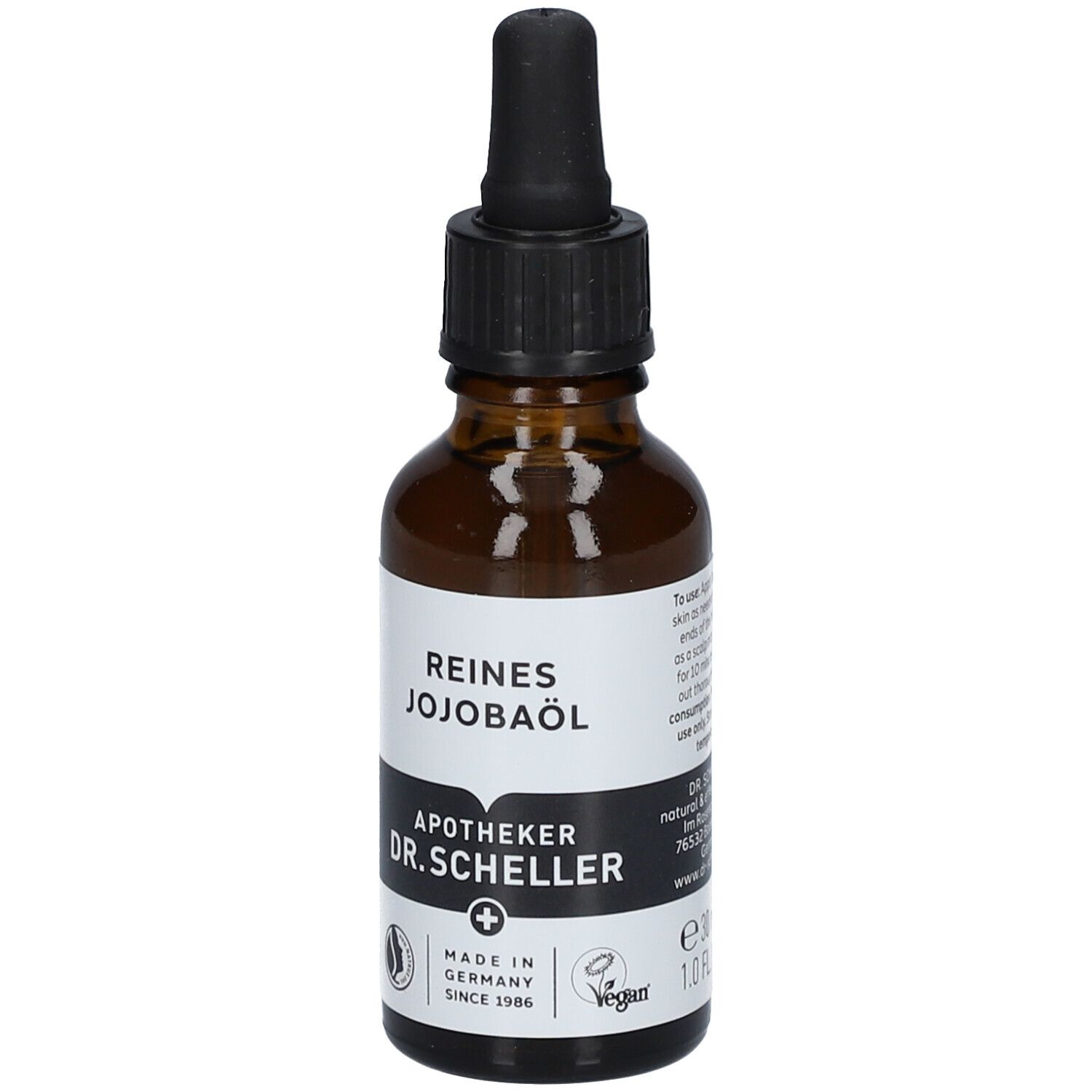 Flacon en verre brun avec pipette. Étiquette avec texte: REINES JOJOBAÖL, Apotheker DR.SCHELLER. Vegan. Fabriqué en Allemagne.