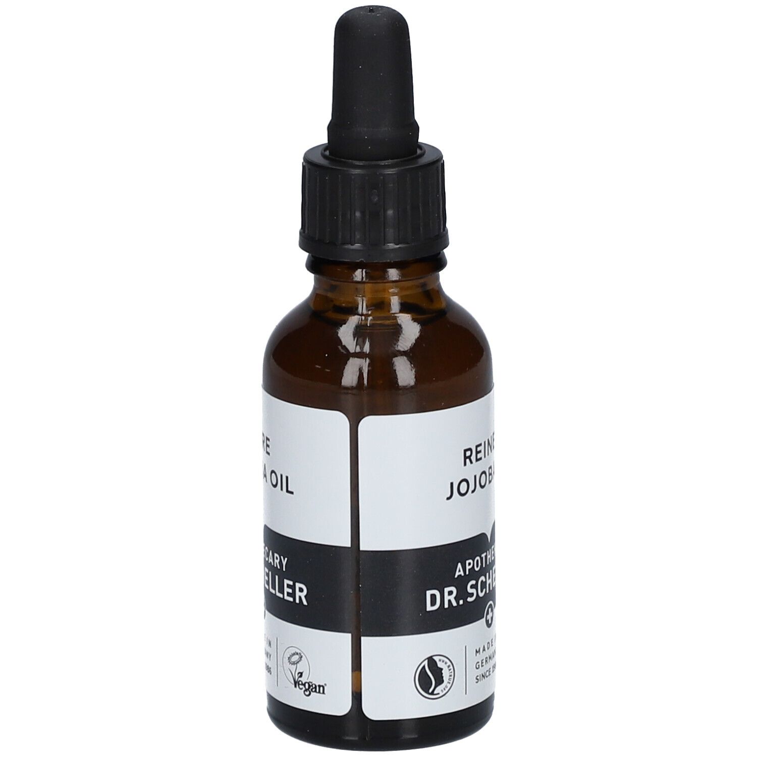 Flacon en verre brun avec pipette. Étiquette avec texte: REINES JOJOBAÖL, Apotheker DR.SCHELLER. Vegan. Fabriqué en Allemagne.