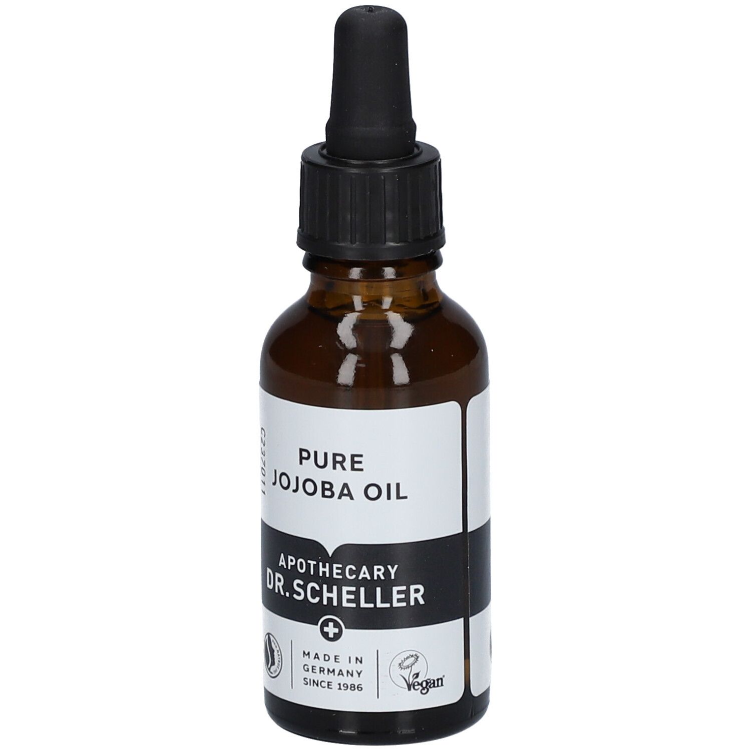Flacon en verre brun avec pipette. Étiquette avec texte: PURE JOJOBA OIL, Apotheker DR.SCHELLER. Vegan. Fabriqué en Allemagne.