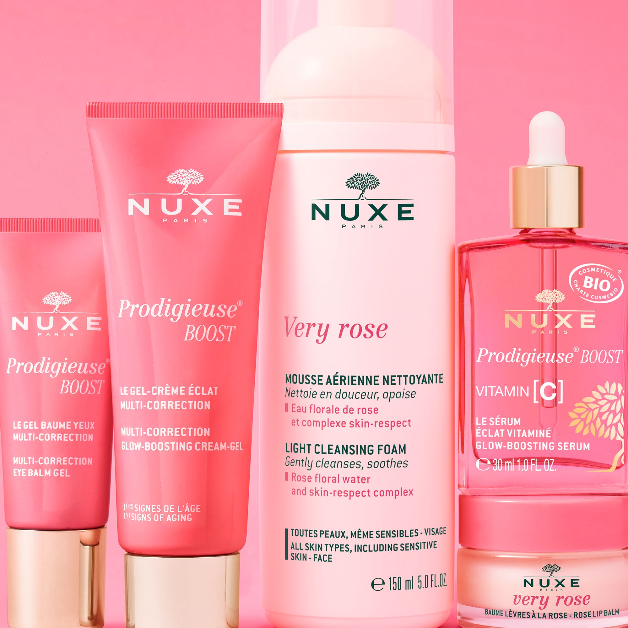 Divers produits NUXE sur fond rose. Dont: Prodigieuse Boost, Very Rose.