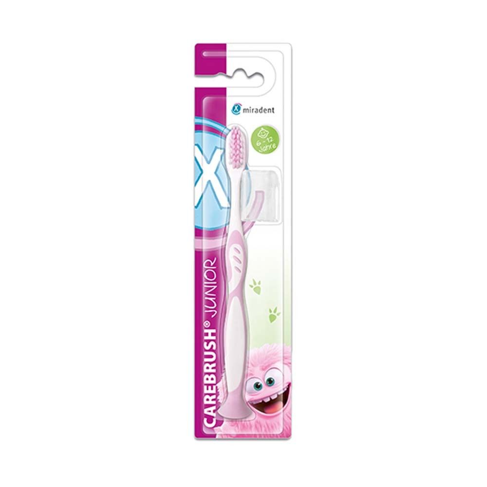 Brosse à dents Carebrush Junior rose, emballée. Logo Miradent. Recommandé pour 6-12 ans. Avec étui de protection et ventouse.