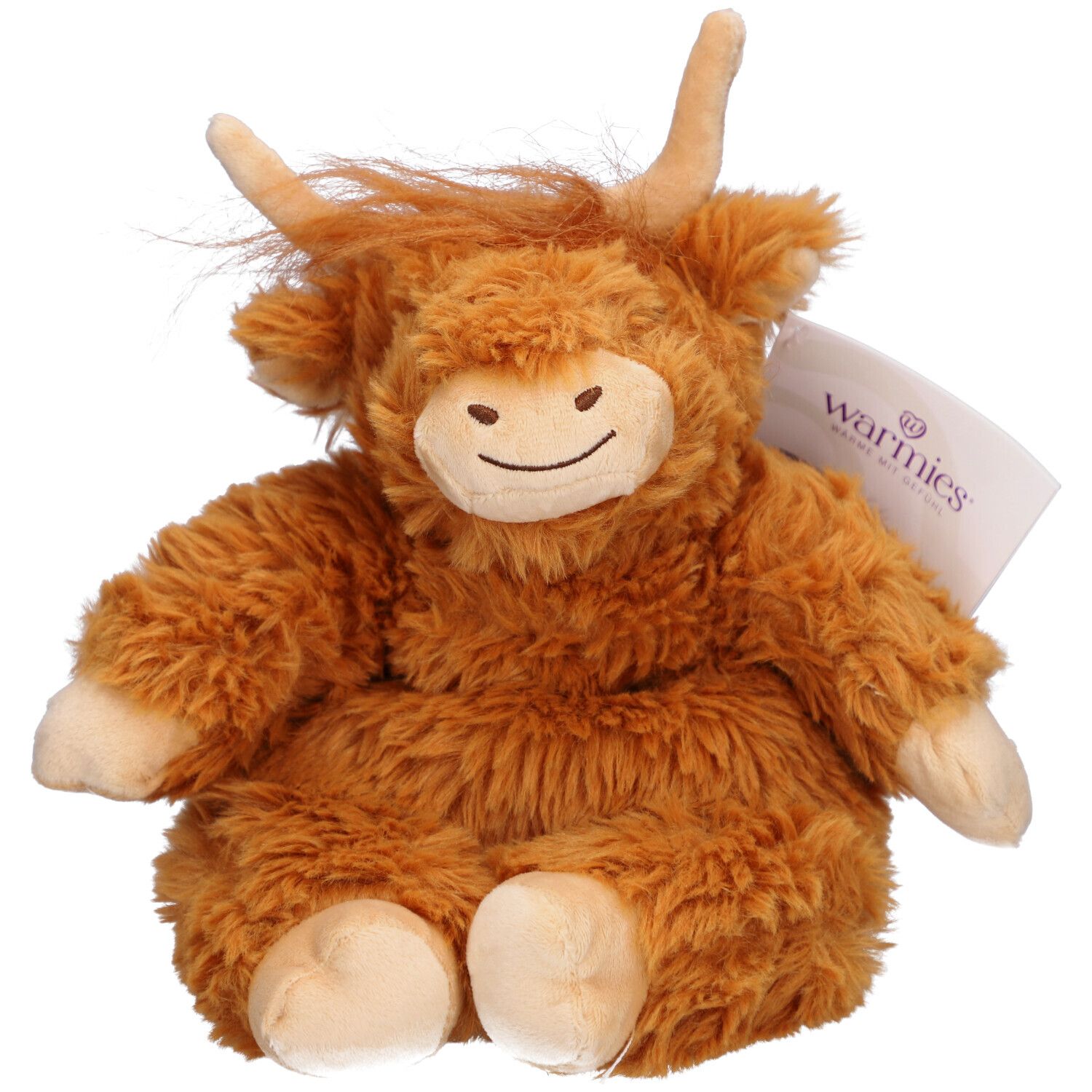 Peluche marron en forme de vache des Highlands, avec cornes et visage souriant. Une étiquette avec le logo "Warmies" est attachée.