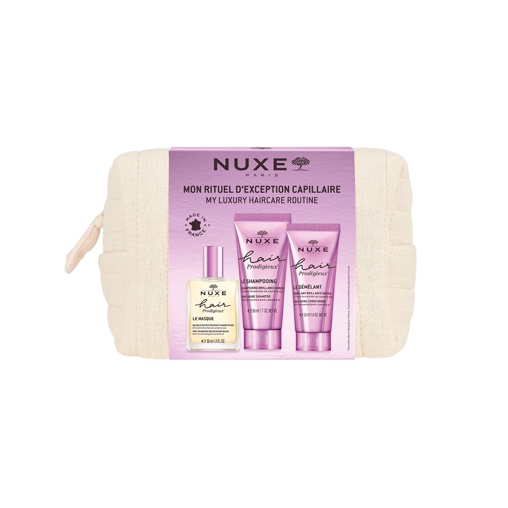 Trousse de toilette beige avec trois produits capillaires. Flacon et deux tubes. Inscription : NUXE, Hair Prodigieux.