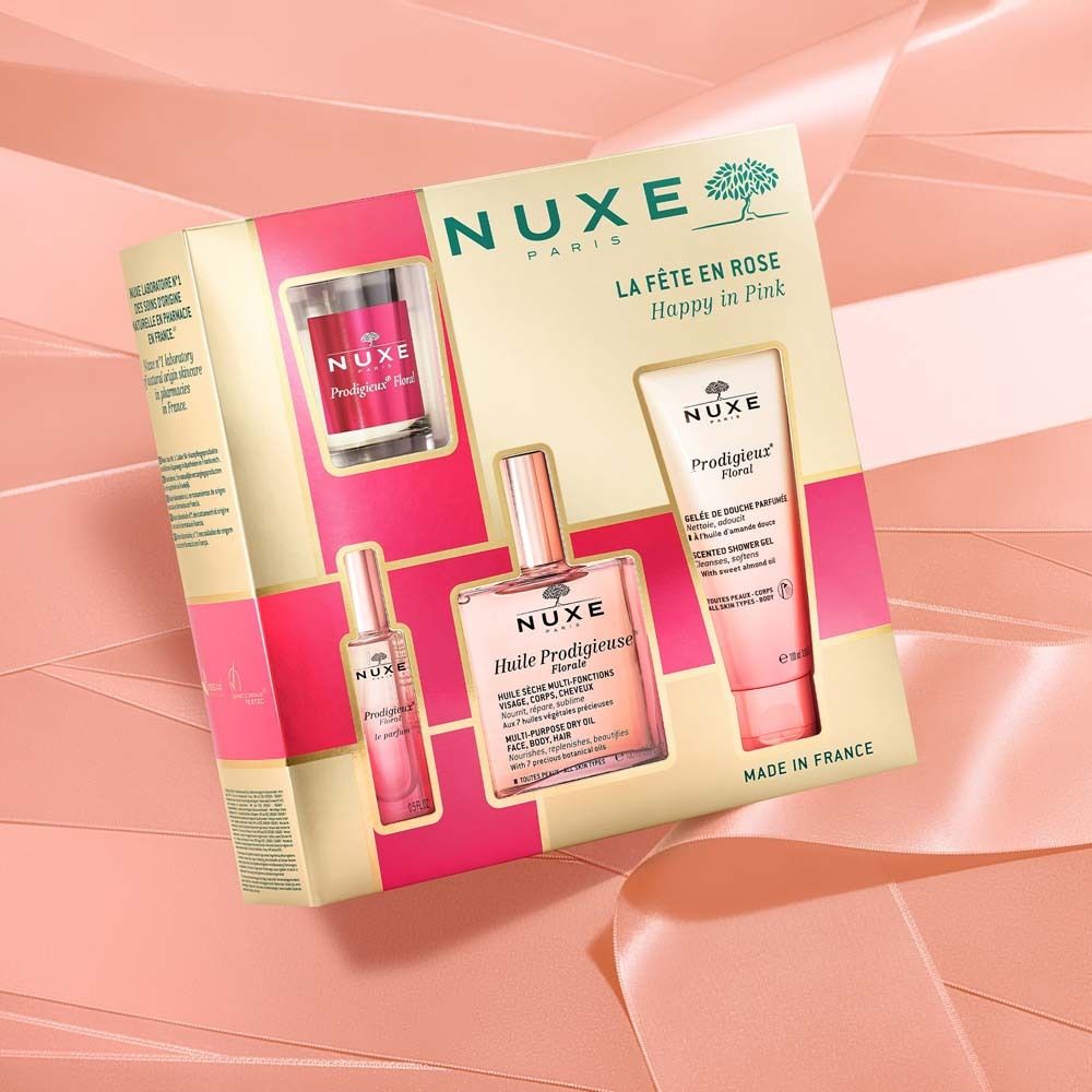 Coffret cadeau NUXE dans une boîte rose et dorée. Contient plusieurs produits.