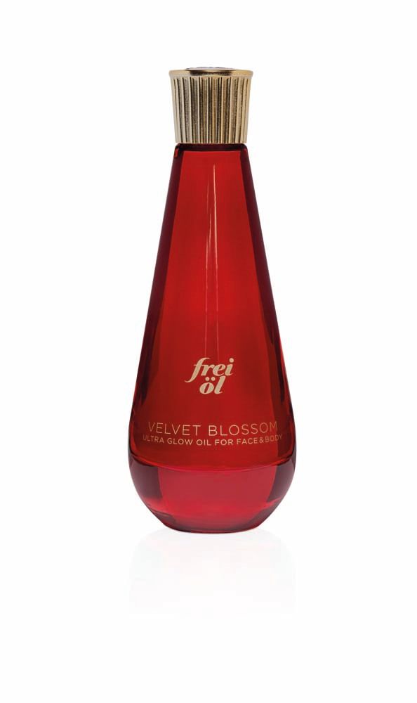Flacon rouge avec bouchon doré. Inscription : frei öl, Velvet Blossom, Ultra Glow Oil.