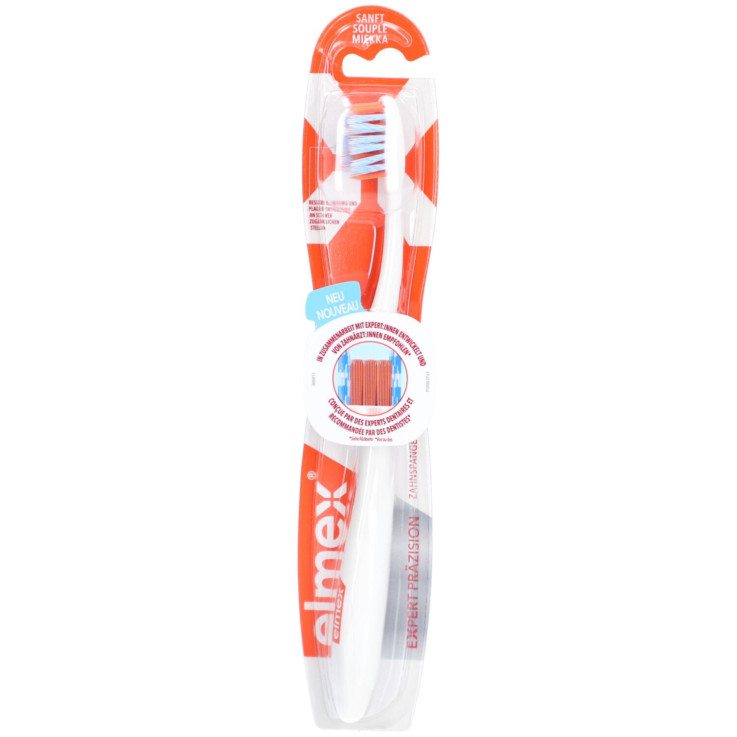 Brosse à dents dans son emballage. Manche blanc, tête bleue. Inscriptions "elmex" et "Expert Präzision".