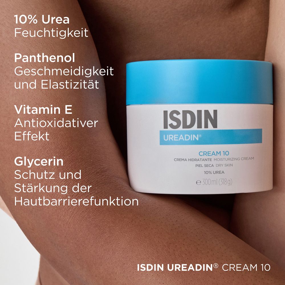 Pot de crème à couvercle bleu. Inscription: ISDIN UREADIN CREAM 10. Texte: 10% Urée, Panthénol, Vitamine E, Glycérine.