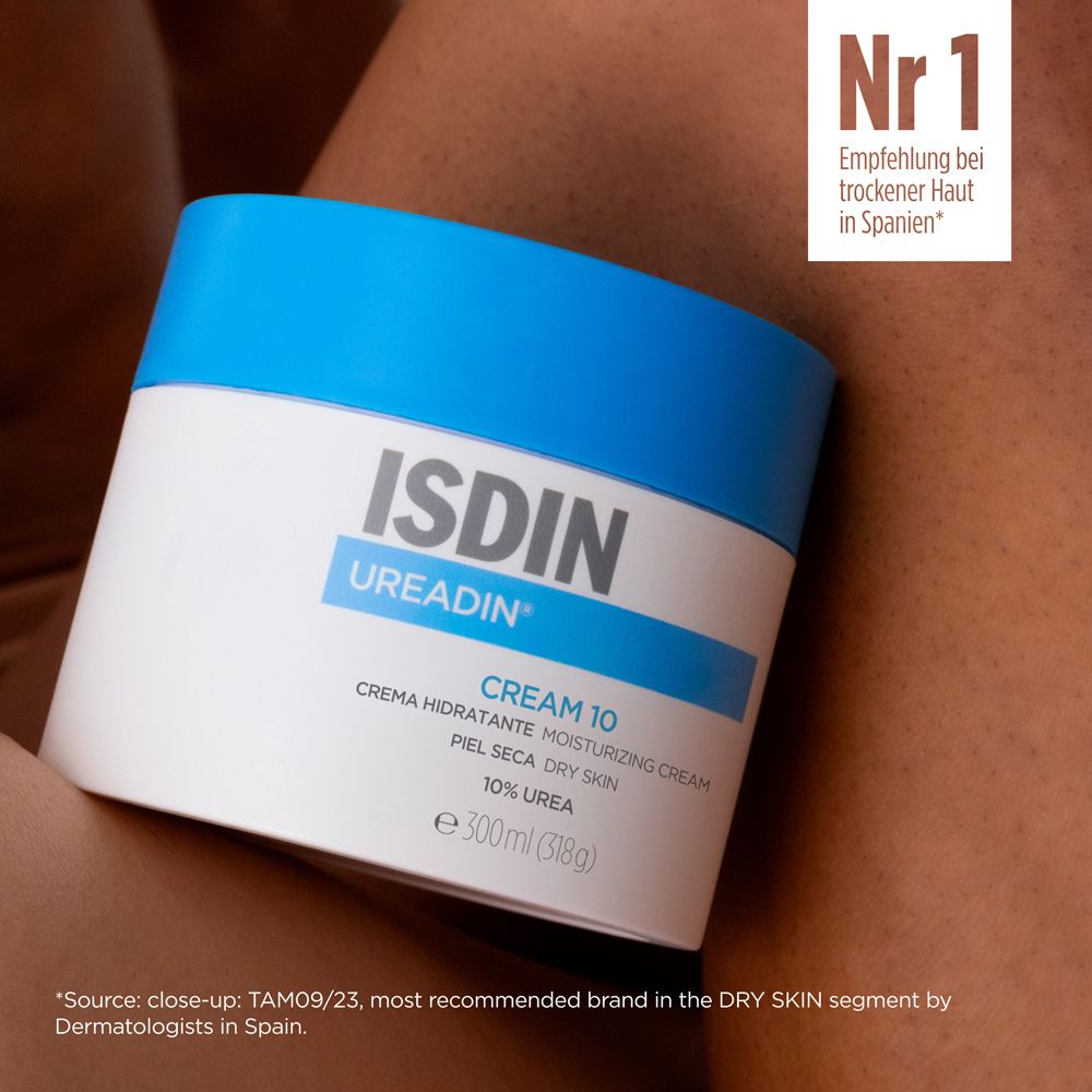 Pot de crème à couvercle bleu. Inscription: ISDIN UREADIN CREAM 10. Texte: Recommandation pour peau sèche en Espagne.