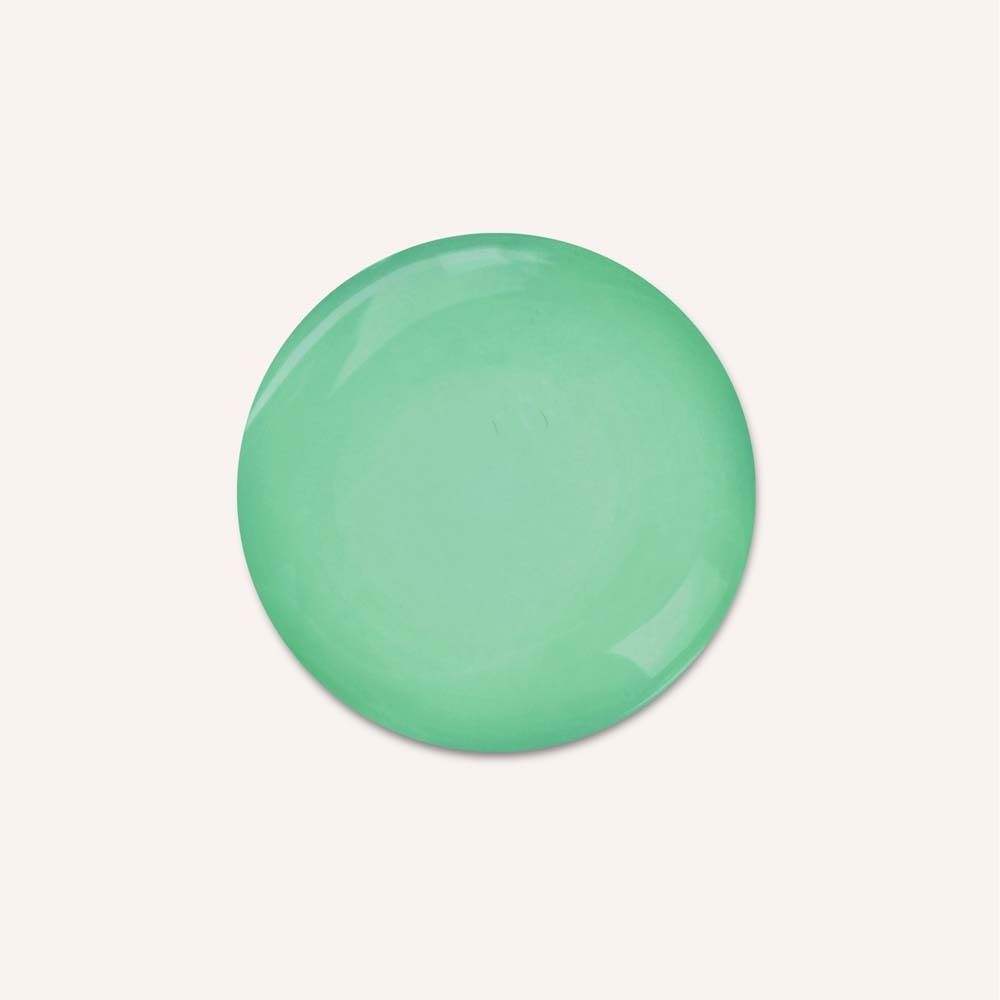 Tache ronde verte sur fond clair.