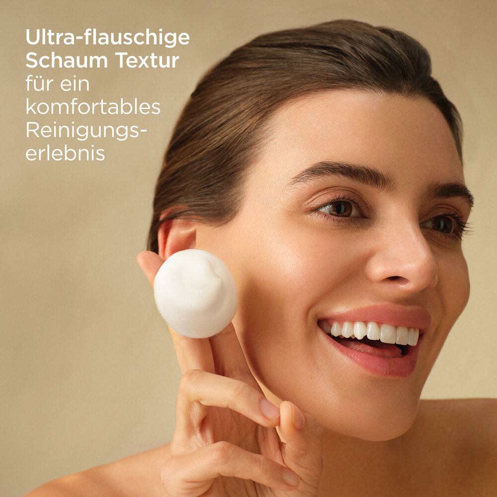 Femme avec mousse dans la main. Texte : Texture mousse ultra-douce pour une expérience nettoyante confortable.