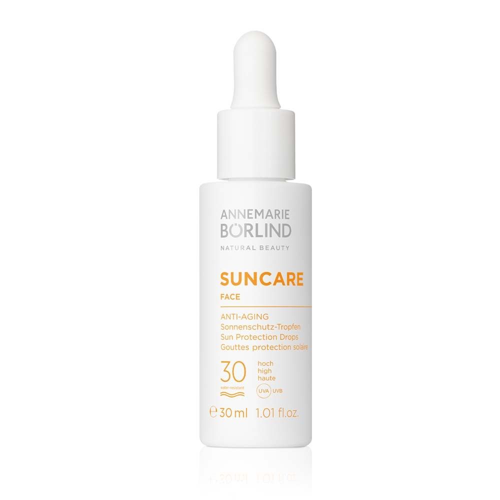 Flacon blanc avec pipette. Inscription : Suncare Face, Anti-Âge, SPF 30. 30 ml.
