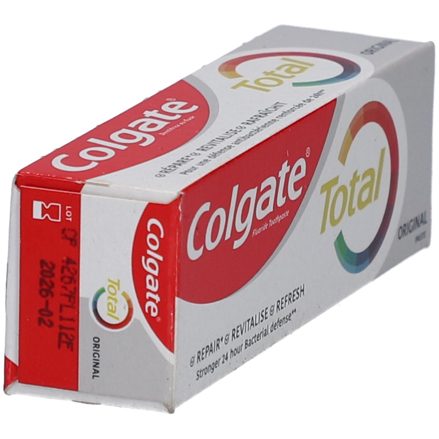 Emballage de dentifrice Colgate Total Original. Couleurs rouge et blanc. Inscription : Colgate Total Original. Date de péremption.