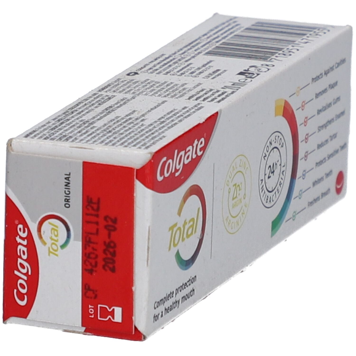 Emballage de dentifrice Colgate Total Original. Couleurs rouge et blanc. Inscription : Colgate Total Original. Date de péremption.