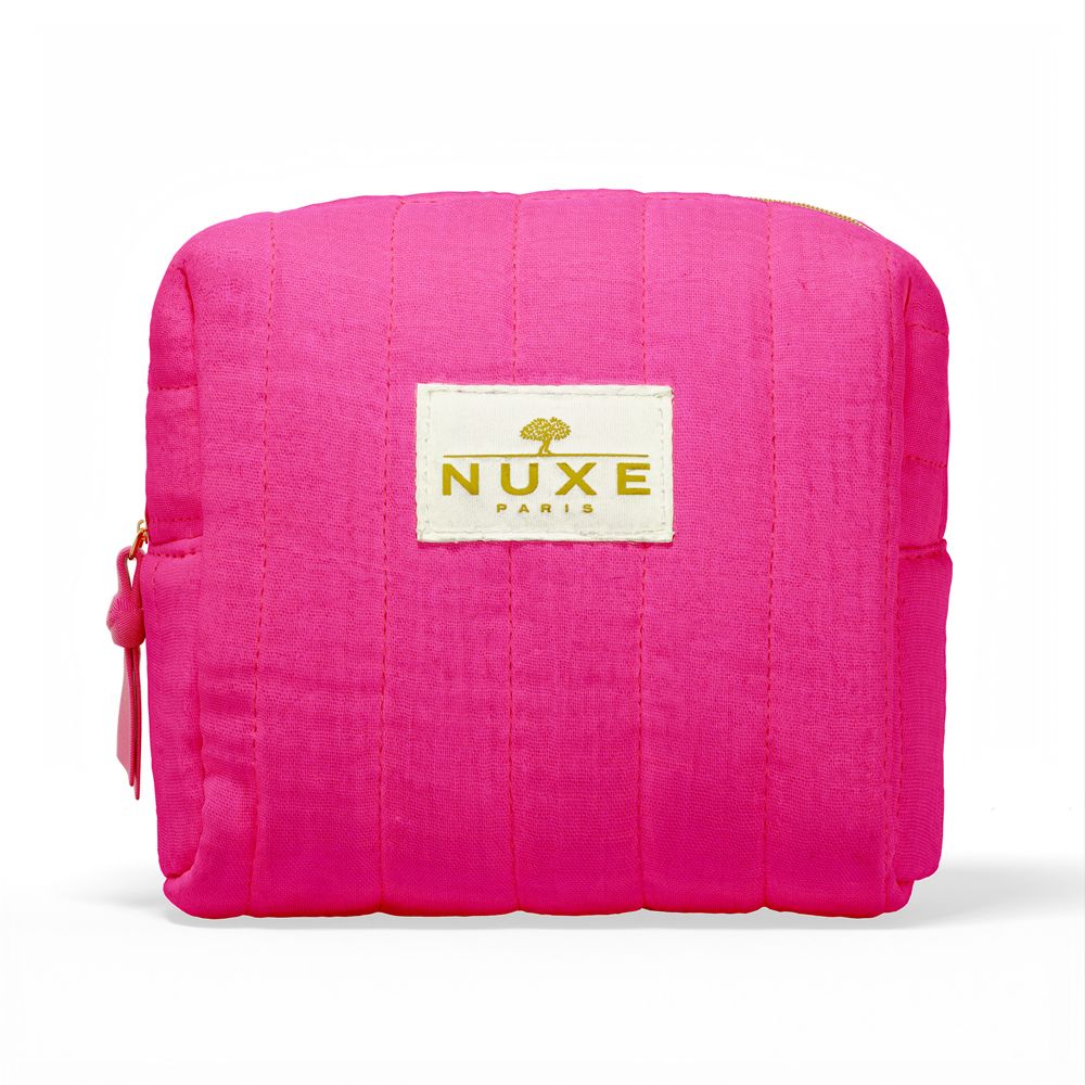 Trousse de toilette rose avec fermeture éclair dorée et logo "NUXE PARIS".