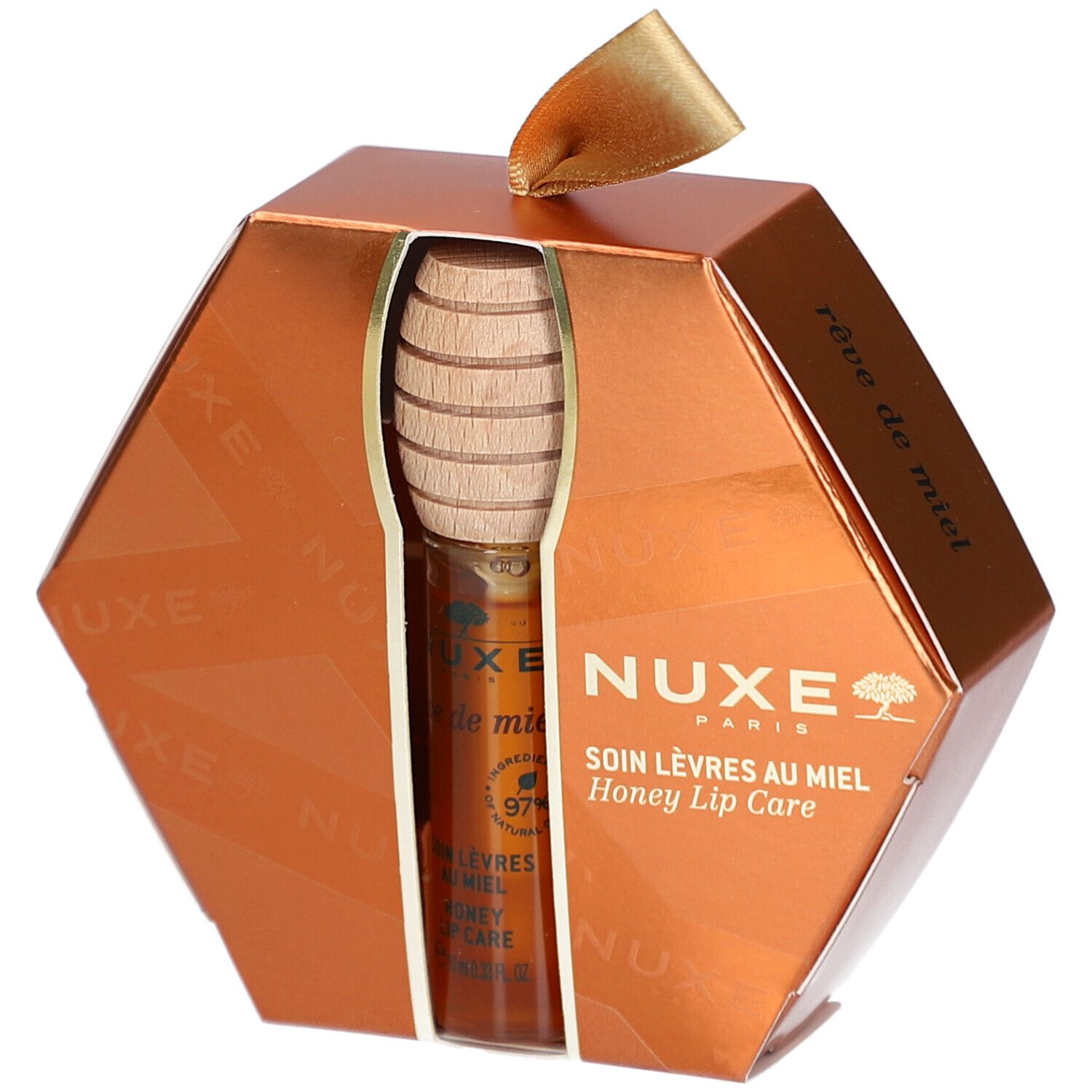Coffret cadeau soin des lèvres au miel. Emballage hexagonal doré avec produit et cuillère à miel. Logo NUXE visible.