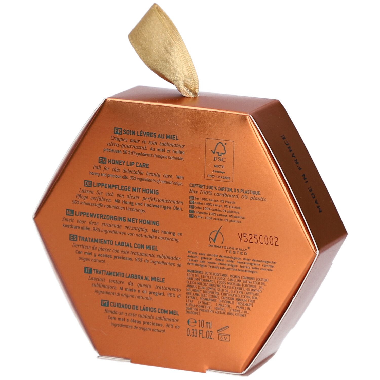 Dos de l'emballage hexagonal doré. Texte multilingue. Logo FSC et autres certifications.