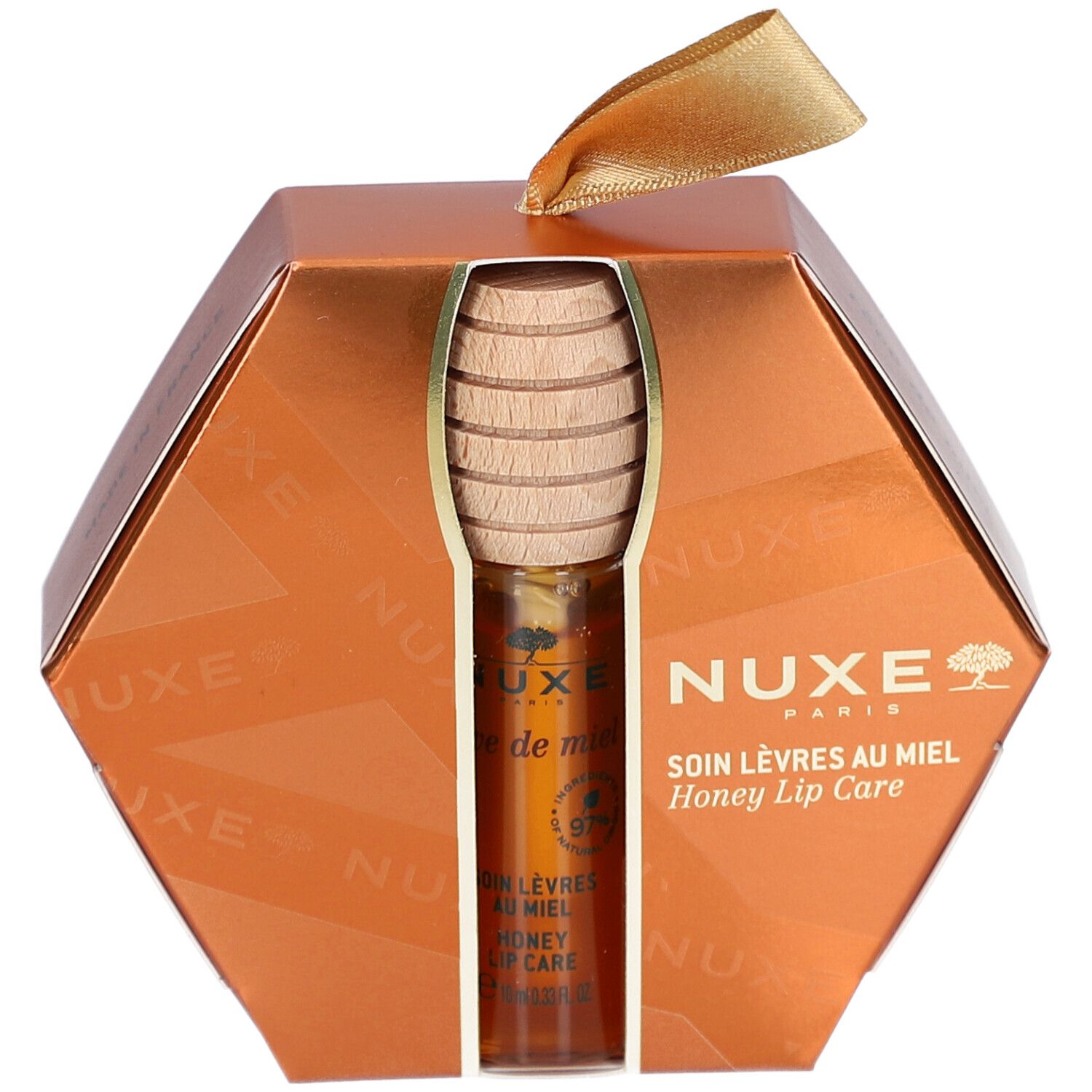 Coffret cadeau soin des lèvres au miel. Emballage hexagonal doré. Produit et cuillère à miel visibles. Logo NUXE.