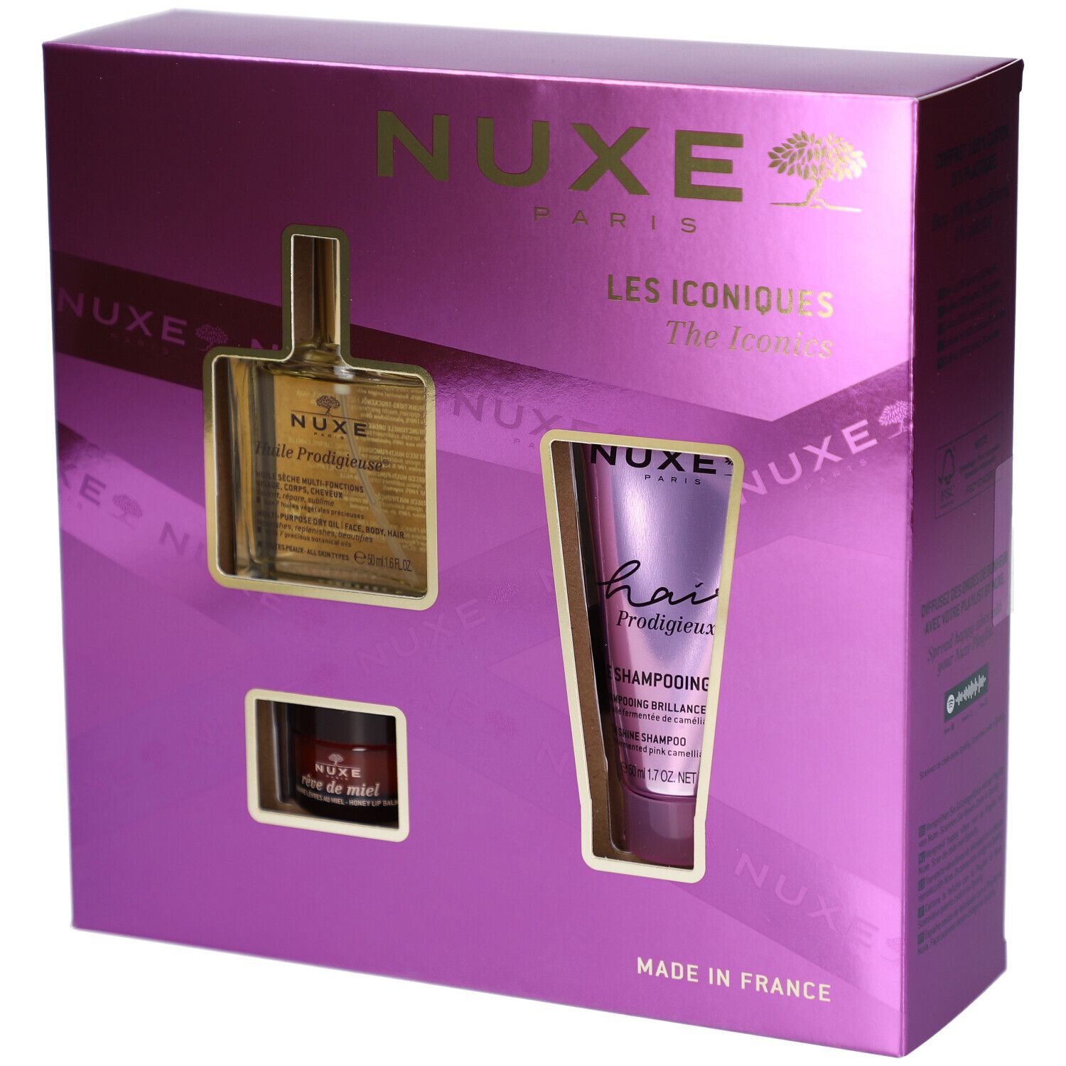 Coffret cadeau violet avec trois produits : huile, shampooing et crème. Le nom de la marque NUXE est visible. « Les Iconiques » est inscrit.