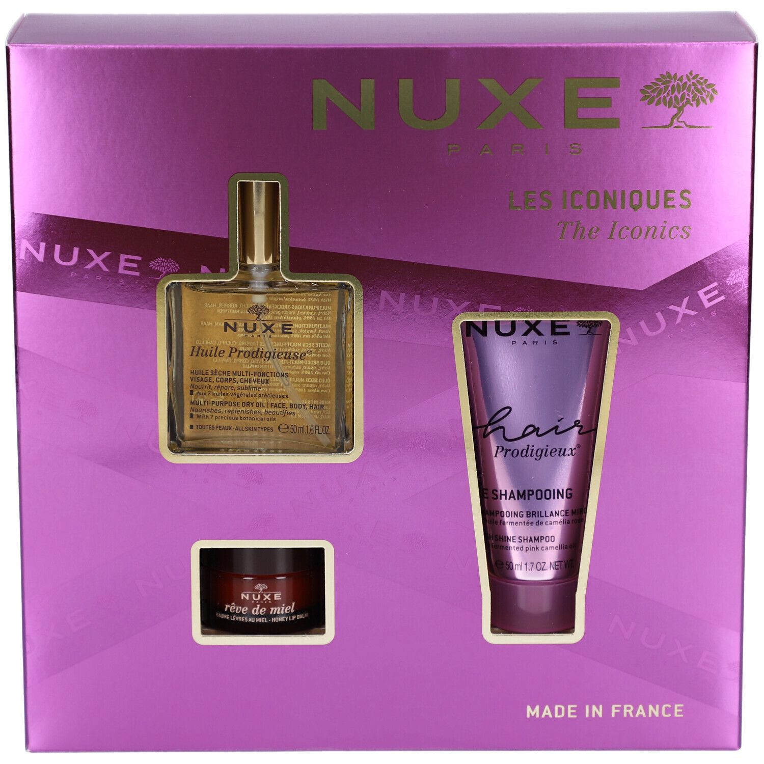 Coffret cadeau violet avec trois produits : huile, shampooing et crème. Le nom de la marque NUXE est visible. "Les Iconiques" est inscrit.