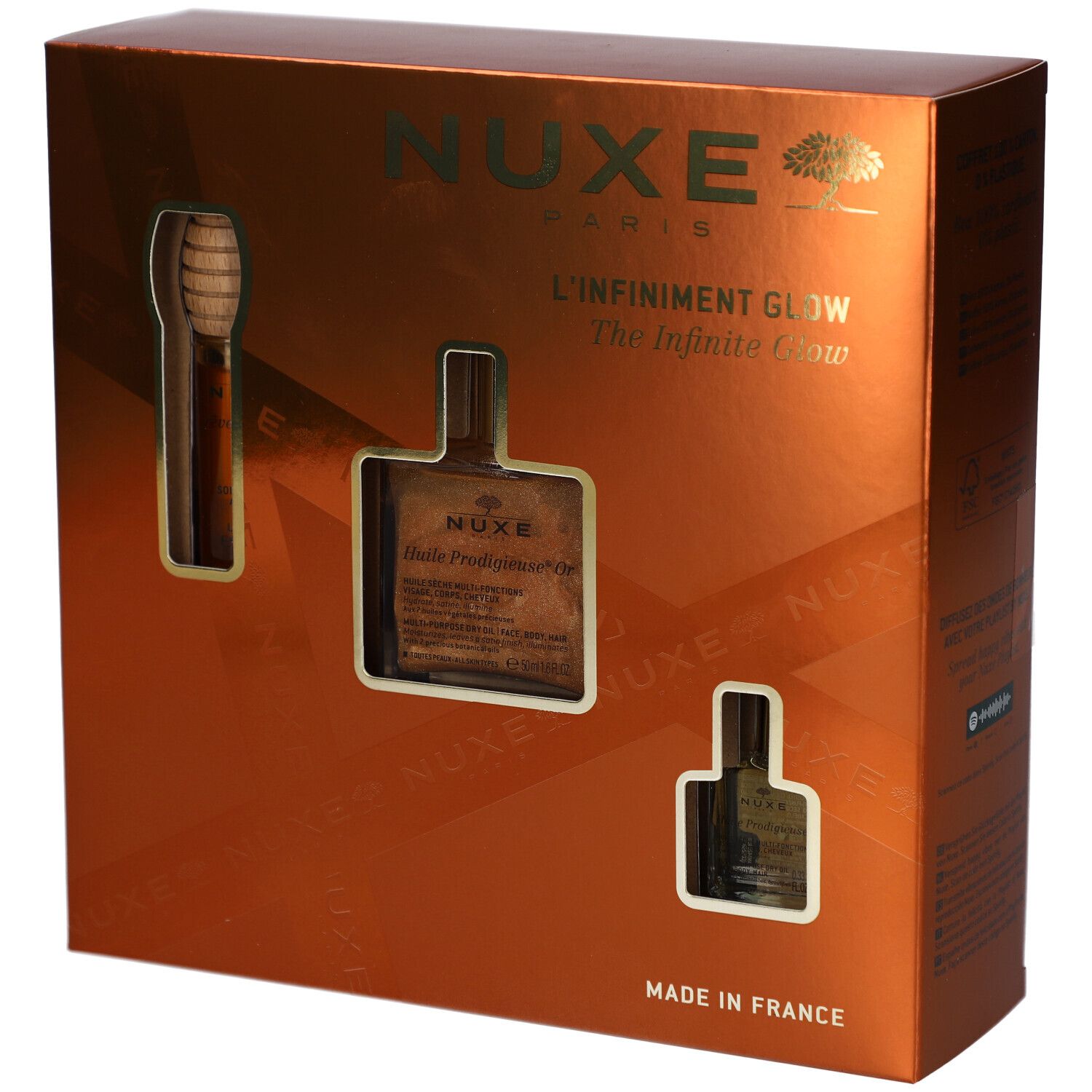Coffret cadeau avec trois produits. Logo NUXE, inscription "L'Infiniment Glow". Fabriqué en France. Emballage doré.