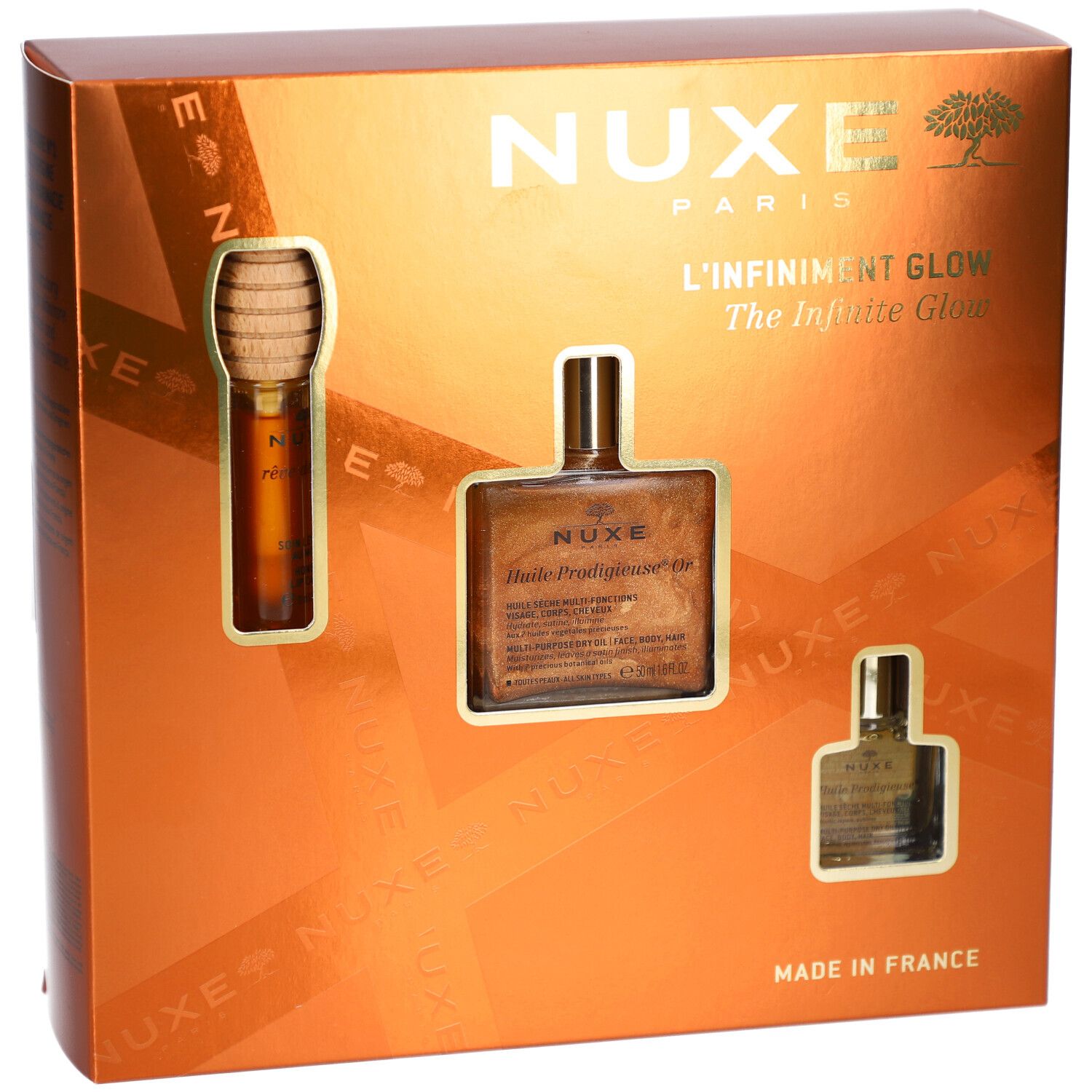 Coffret cadeau avec trois produits. Logo NUXE, inscription "L'Infiniment Glow". Emballage doré.