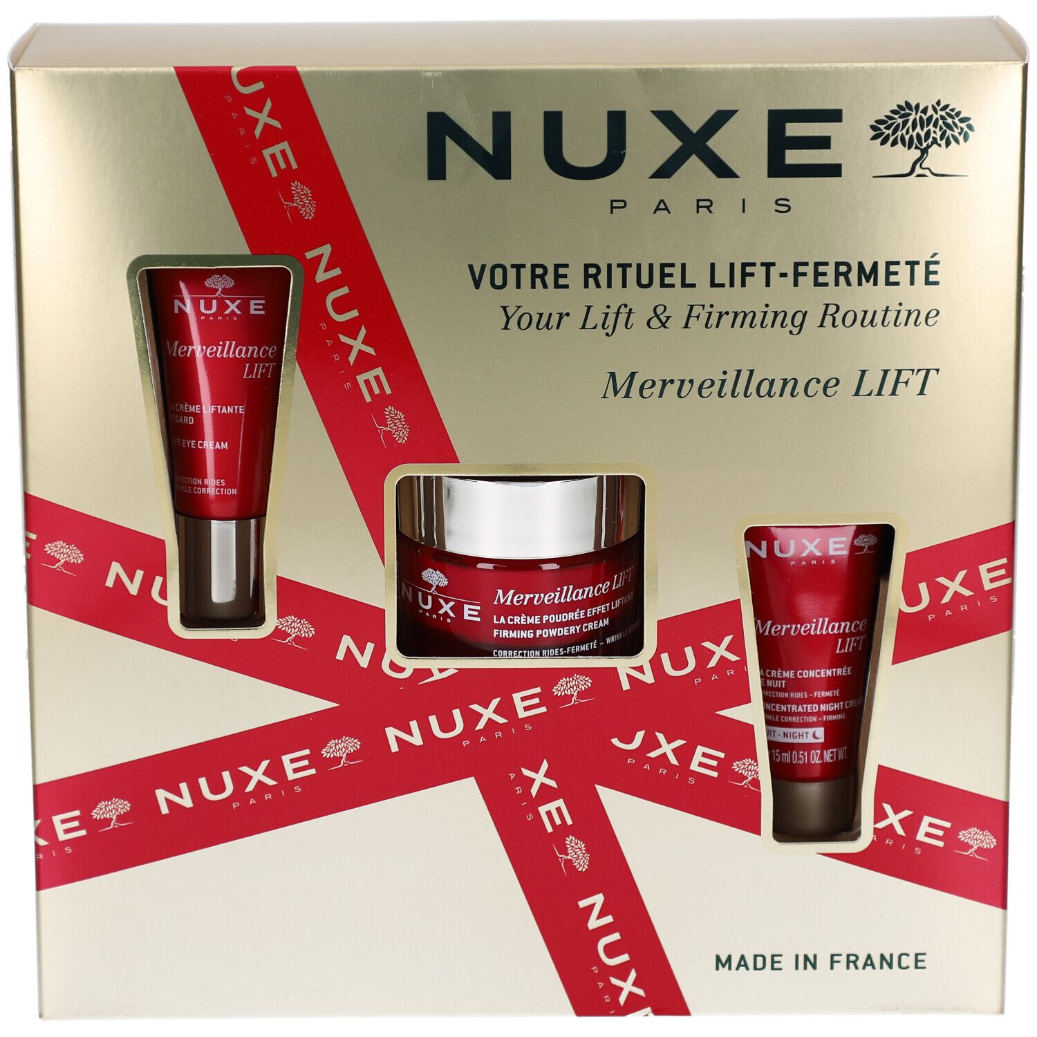 Coffret cadeau avec trois produits cosmétiques. Boîte dorée avec ruban rouge et fenêtres produits. Logo NUXE.