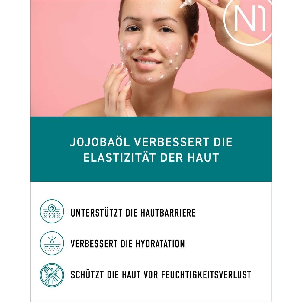 Femme appliquant de la crème. Texte : L'huile de jojoba améliore l'élasticité de la peau. Soutient la barrière cutanée.