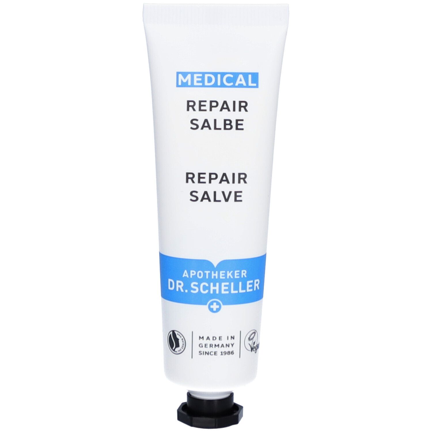 Tube blanche avec bande bleue. Inscription: MEDICAL REPAIR SALBE. Apotheker Dr. Scheller. Vegan.