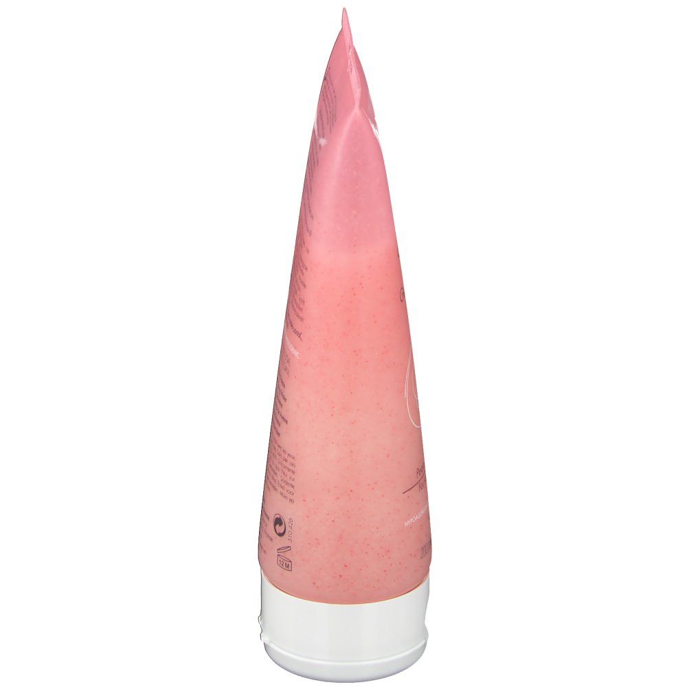 Vue latérale d'un tube rose avec bouchon blanc. Texte illisible.