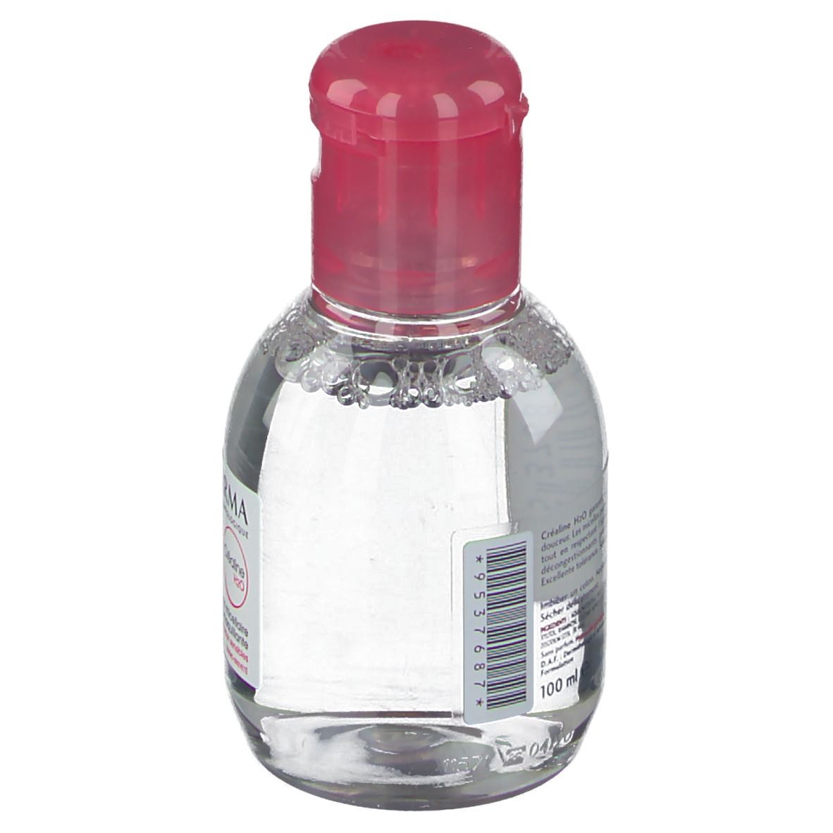 Petite bouteille ovale avec bouchon rose. Étiquette avec code-barres et indication de volume: 100 ml.