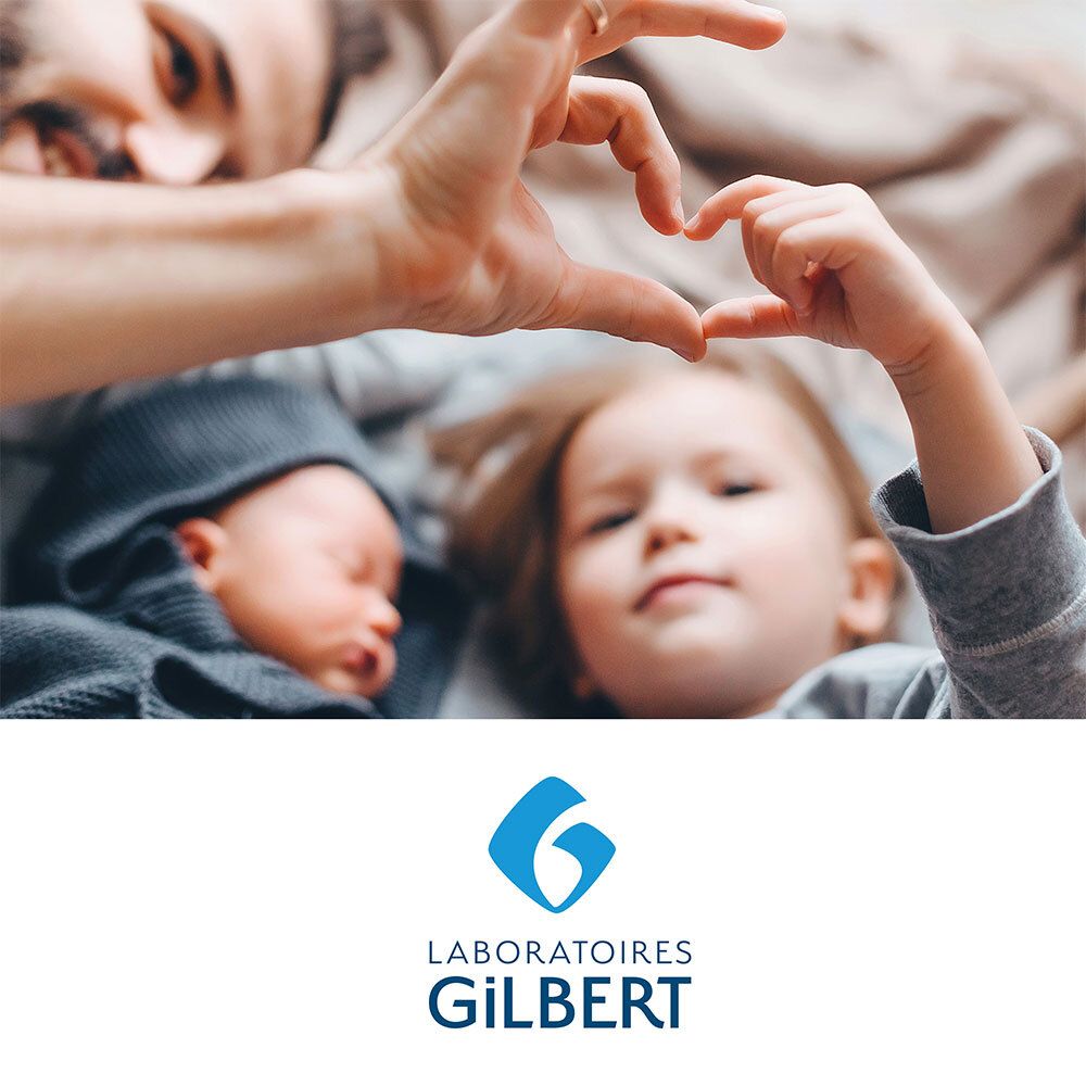 Parents et enfants forment un cœur. Logo : Laboratoires Gilbert. Texte en français.