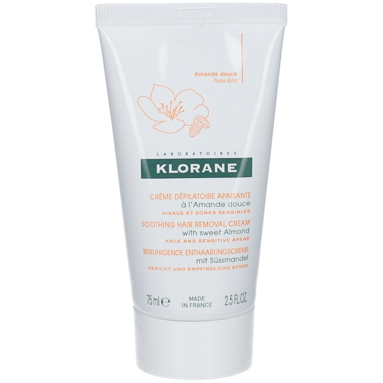 Tube de crème dépilatoire KLORANE. Blanc avec design floral jaune. Texte: Visage et zones sensibles, 75 ml, Fabriqué en France.