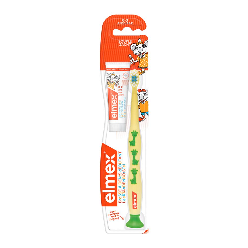 Brosse à dents et dentifrice Elmex en emballage. Manche jaune avec girafes vertes. Pour enfants de 0-3 ans.