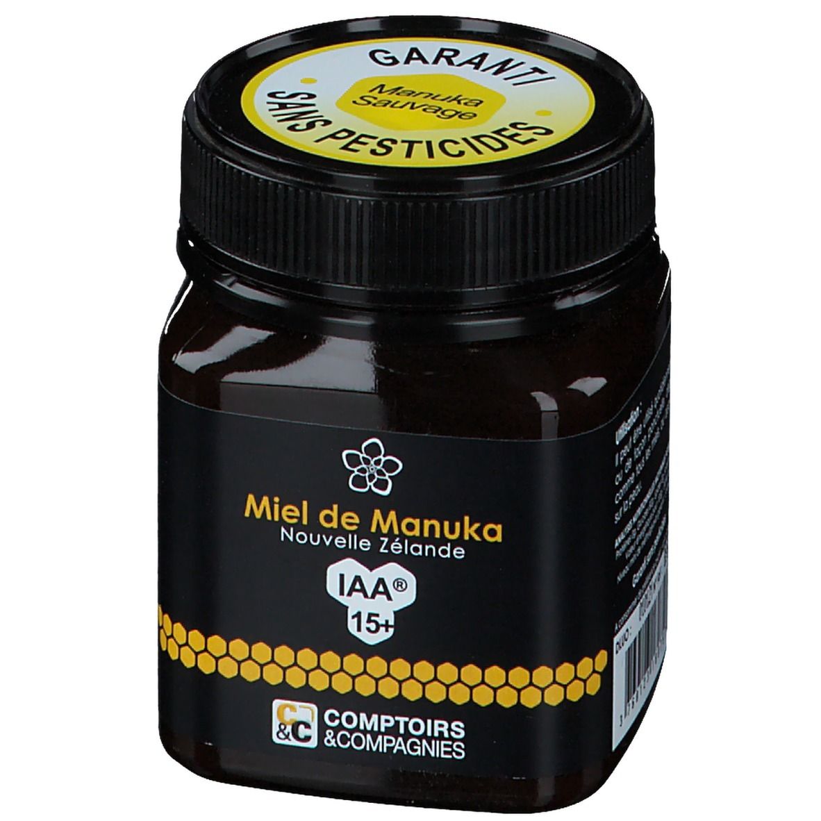 Pot de miel avec étiquette noire. Texte jaune : Miel de Manuka Nouvelle Zélande IAA 15+. Couvercle avec garantie et texte.