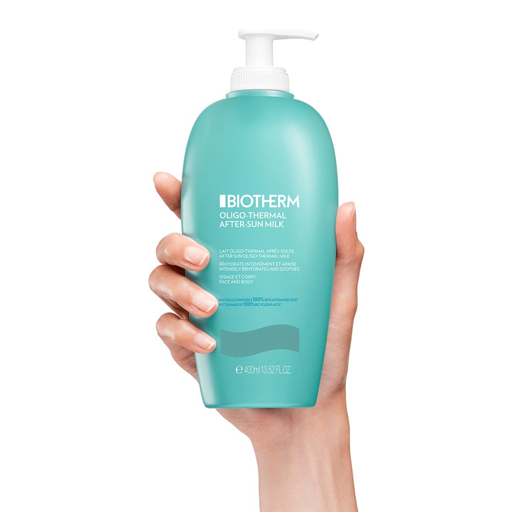 Main tenant un flacon Biotherm Oligo-Thermal Lait Après-Soleil.