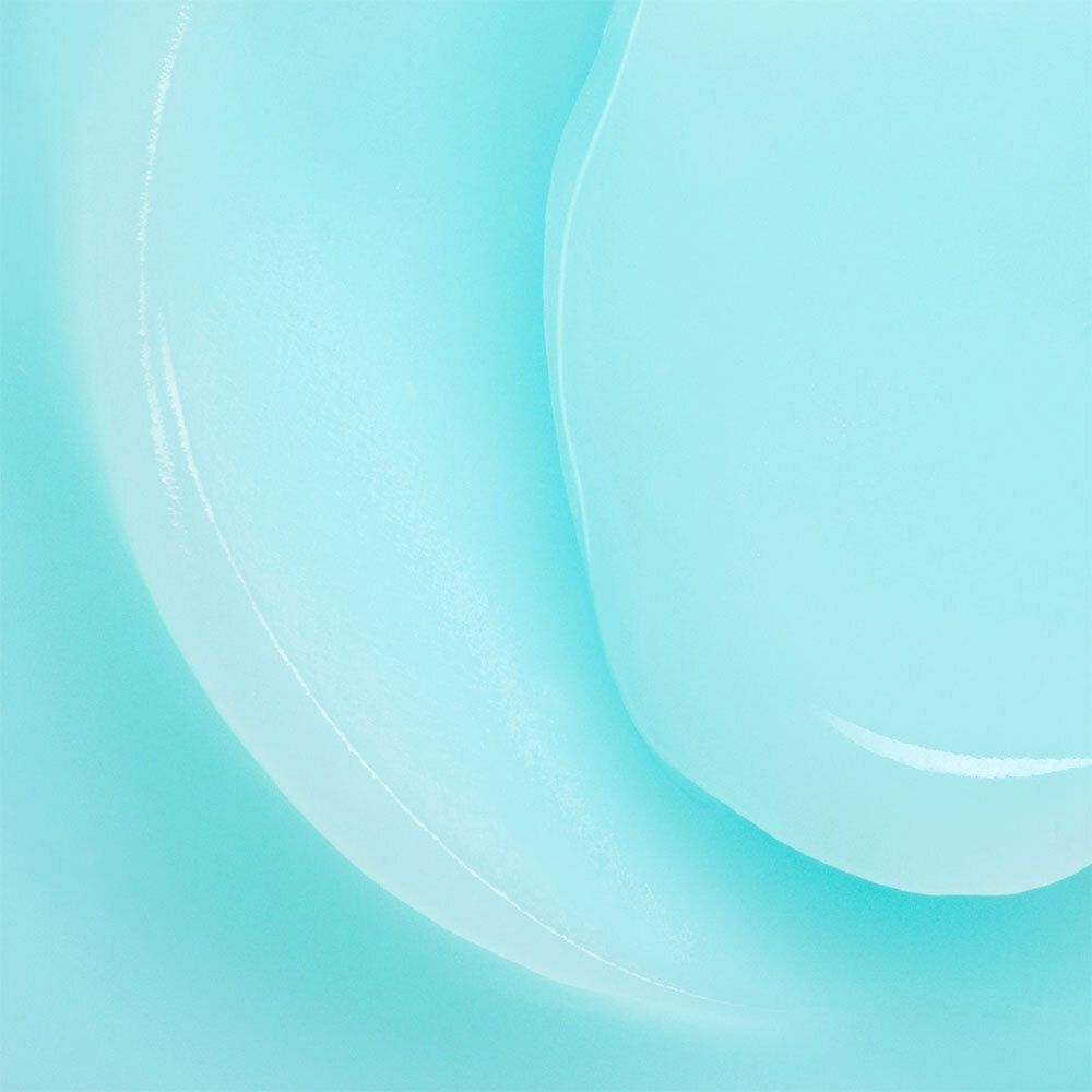 Gros plan d'une substance crémeuse bleu clair avec des motifs ondulés.