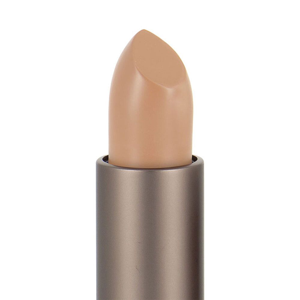 Gros plan sur un correcteur beige clair en bâton. Le bâton est sorti de l'étui.